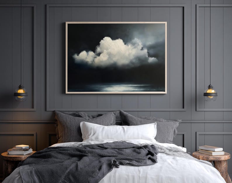 May include: A framed painting of a dramatic cloudscape hangs above a bed with gray and white bedding. The artwork features a large, white cloud against a dark, moody background. Two pendant lights flank the bed, adding to the room's ambiance.