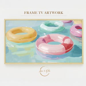 May include: A framed artwork featuring a pool scene with colorful inflatable rings. The rings are in shades of yellow, pink, and teal, floating on a light blue water surface. The artwork is labeled "FRAME TV ARTWORK" at the top.