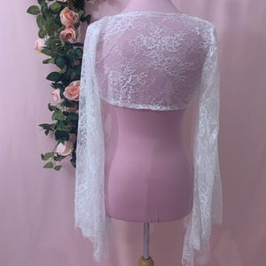 Back view of the 12.5 inch cropped white wedding bolero showing the elegant drape across the shoulders and upper back.