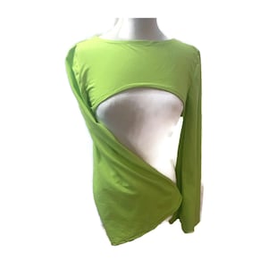 May include: A lime green long-sleeved top with a unique cut-out design. The top features a round neckline and a midriff-baring opening. The sleeves are long and flowing, and the fabric appears to be lightweight and stretchy. The top is displayed on a white mannequin.