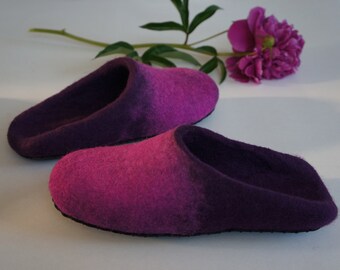 May include: A pair of purple and pink wool slippers. The slippers are made of a soft, fuzzy material and have a comfortable fit.