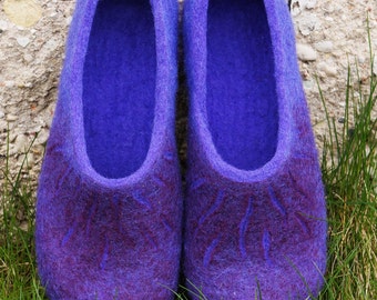 May include: A pair of purple wool slippers with a decorative pattern. The slippers are made of felted wool and have a soft, comfortable feel.