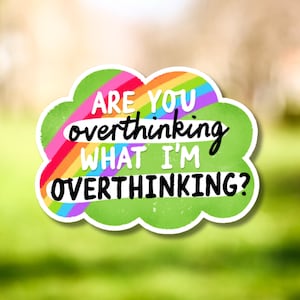 May include: A sticker in the shape of a green cloud with the text "ARE YOU overthinking WHAT I'M OVERTHINKING?" in black and white. A rainbow design is behind the text.