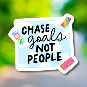May include: A sticker with the text "CHASE goals NOT PEOPLE" in black script. The background is light blue with white clouds. Decorative elements include a rainbow, daisies, and smiley faces.