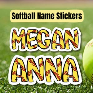May include: Two softball-themed name stickers, one with the name "MEGAN" and the other with the name "ANNA". The stickers are yellow with red stitching and white outlines.