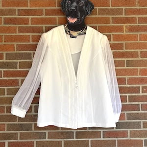 May include: A set of three ceramic mugs with a speckled, matte finish. The mugs are in shades of cream, light gray, and dark gray. Each mug has a simple, minimalist design, perfect for coffee or tea.