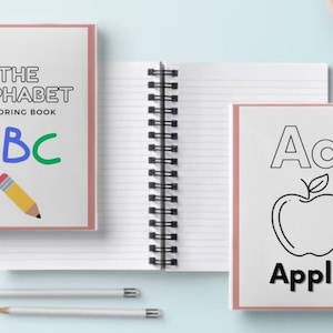 May include: Two pink spiral bound notebooks. The first notebook has the text "THE ALPHABET COLORING BOOK" and the letters "ABC" in red, blue, and green. The second notebook has the letter "Aa" and a black and white outline of an apple with the word "Apple" below it.