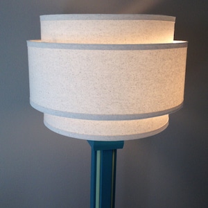 3-Tier 18" hardback lamp shade in off-white muslin fabric with edge trimming, best for floor lamps or large table lamps.