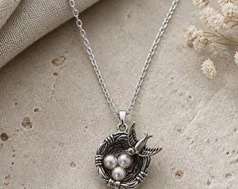 Mama bird in a nest pendant necklace