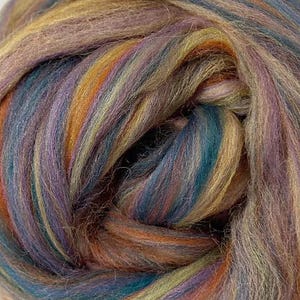 May include: A ball of roving wool fiber featuring a variegated color palette of deep teal, burnt orange, golden yellow, and muted purple tones. The fibers are loosely twisted together, creating a soft, textured appearance with blended colors.