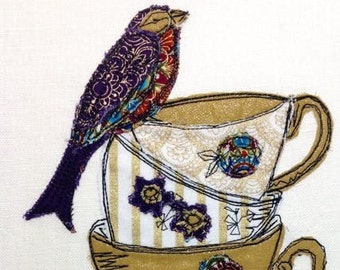 May include: A stack of three teacups with a purple bird perched on top. The cups are decorated with floral and geometric patterns in shades of gold, purple, red, and blue.