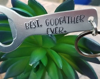 May include: Silver bottle opener keychain with the text "Best. Godfather. Ever." engraved on it.