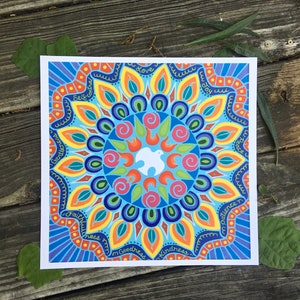 May include: A colorful mandala design with a white dove in the center. The mandala is surrounded by a circle of words, including "love", "joy", "peace", "patience", "kindness", "goodness", "faithfulness", "gentleness", "self-control", and "wisdom".