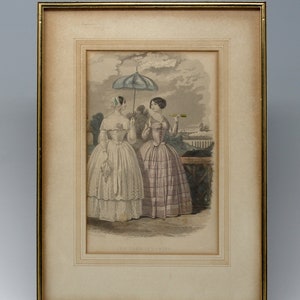 May include: A framed print of two women in 19th-century fashion, one holding an umbrella and the other a telescope, standing on a path in a park.