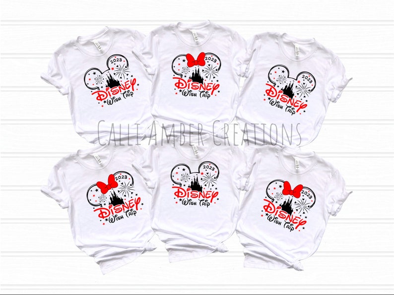 May include: Five white t-shirts with a black and red graphic design of Mickey Mouse ears with a red bow, fireworks, and the text "2023 DISNEY Wish Trip".
