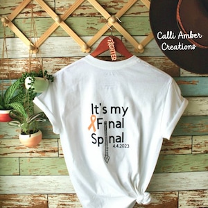 May include: White t-shirt with the text "It's my Final Spinal" and an orange ribbon. The text "4.4.2023" is below the spinal graphic.