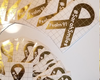 May include: A stack of gold and brown vinyl stickers with a white ribbon design and the text "#SarahSmiles" and "Psalm 91".