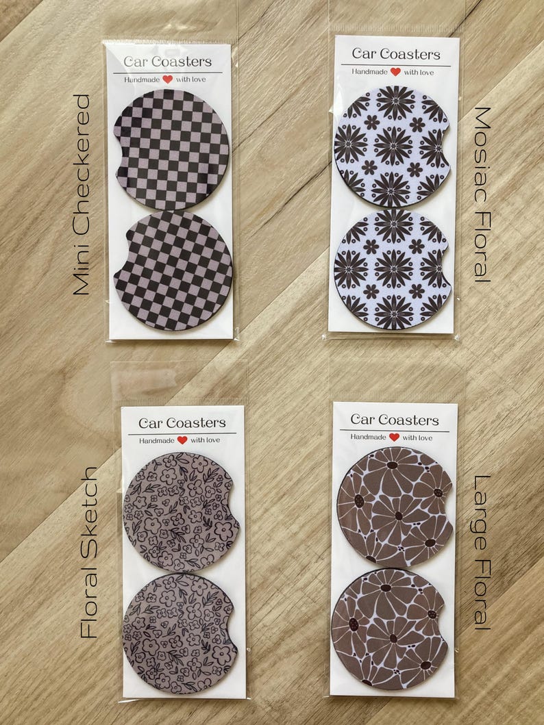 May include: Set of four car coasters featuring different floral and geometric designs. The coasters are packaged in clear plastic bags with labels that say "Car Coasters" and "Handmade with love". The designs include a mini checkered pattern, a mosaic floral pattern, a floral sketch pattern, and a large floral pattern.