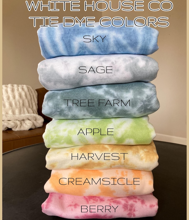 May include: A stack of tie-dye fabric swatches in various colours, including sky blue, sage green, tree farm green, apple green, harvest orange, creamsicle orange, and berry pink. The fabric swatches are labelled with the colour names.