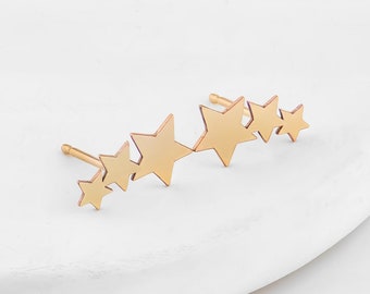 May include: Gold ear cuff with a row of five star-shaped charms.