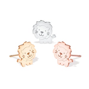 May include: Three lion stud earrings in silver, rose gold, and gold.
