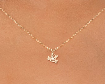 May include: A gold chain necklace with a delicate frog pendant.