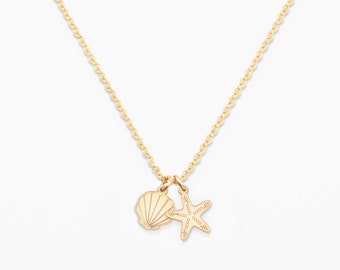 May include: A gold chain necklace with a seashell and starfish charm.