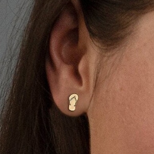 May include: Gold-toned flip-flop stud earrings. The earrings are small and delicate, and they are perfect for adding a touch of whimsy to any outfit.