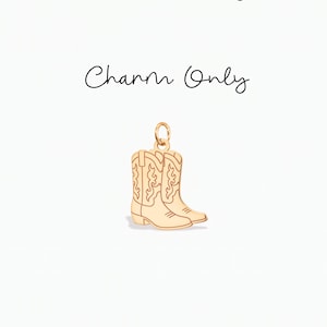 May include: A gold-toned metal charm shaped like a pair of cowboy boots with engraved decorative stitching details. The charm features a small circular jump ring at the top for attachment. The text "Charm Only" is printed above the object.