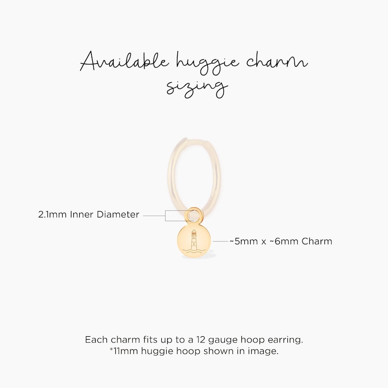 May include: Gold huggie hoop earring with a small lighthouse charm. The hoop is 2.1 mm in diameter and the charm is approximately 5 mm by 6 mm.  Each charm fits up to a 12 gauge hoop earring.  The image shows an 11 mm huggie hoop.