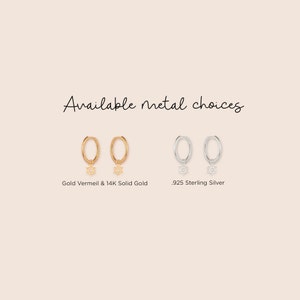 May include: Two pairs of hoop earrings with a dangling Star of David charm. The earrings are available in gold vermeil and 14K solid gold, and .925 sterling silver.