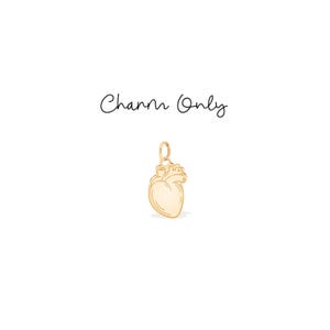 May include: A gold-coloured charm in the shape of a human heart. The charm has a small loop at the top for attaching to a necklace or bracelet. The words "Charm Only" are written in cursive above the charm.
