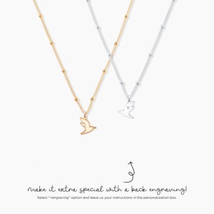May include: Two necklaces with bird pendants. One is gold-toned, the other silver-toned, both with delicate chain and bead accents. The silver necklace features the letter "K" on the bird pendant. Text reads "make it extra special with a back engraving!"