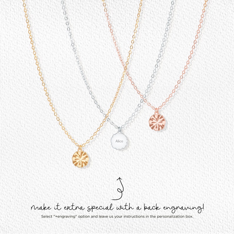 May include: Three delicate necklaces in gold, silver, and rose gold. Each necklace features a small, round pendant with a sunburst design. One pendant is engraved with the name "Alice". The image includes text that reads "make it extra special with a back engraving!"