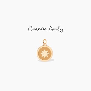 May include: Gold charm featuring a sun design with a yellow center and eight rays. The charm is round and has a smooth, polished finish.