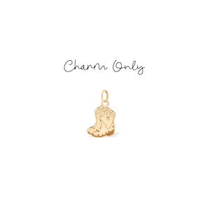 May include: A gold-colored charm in the shape of a cowboy boot. The charm has intricate detailing, including stitching and a heel. The words "Charm Only" are written in cursive above the charm.