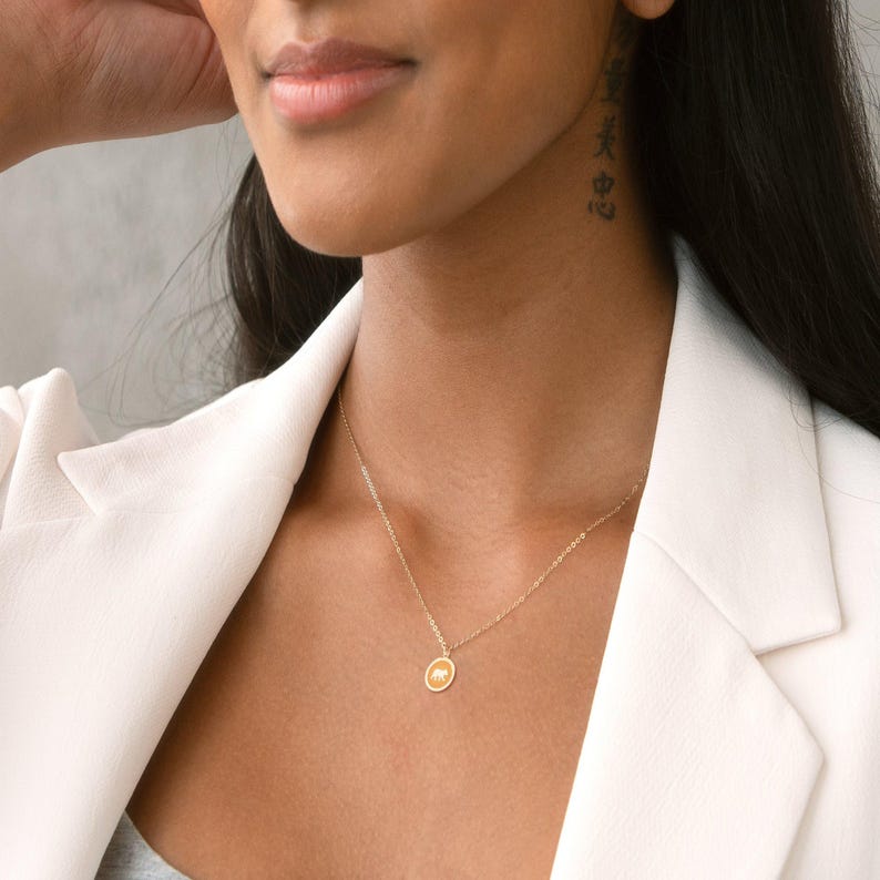 Delicate gold charm necklace featuring a playful animal pendant, perfect for animal lovers or nature enthusiasts. Ideal for casual outings or as a thoughtful gift for wildlife advocates.