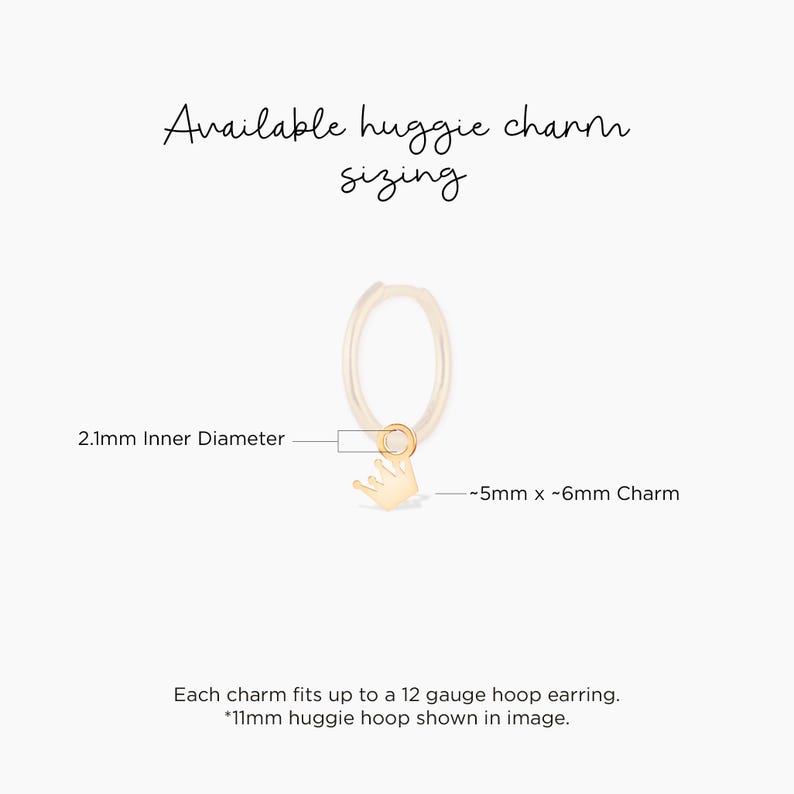 May include: Gold huggie hoop earring with a small crown charm. The hoop is 2.1 mm in diameter and the charm is approximately 5 mm by 6 mm. The charm fits up to a 12 gauge hoop earring.