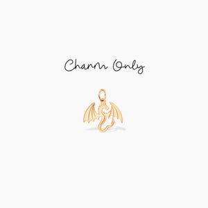 May include: Gold-toned dragon charm with outstretched wings. Charm Only.