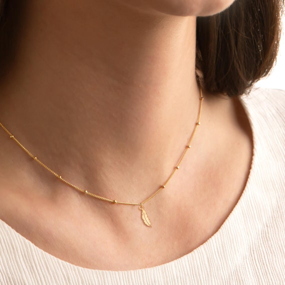Collana di piume origami placcate in oro con piuma in argento 925