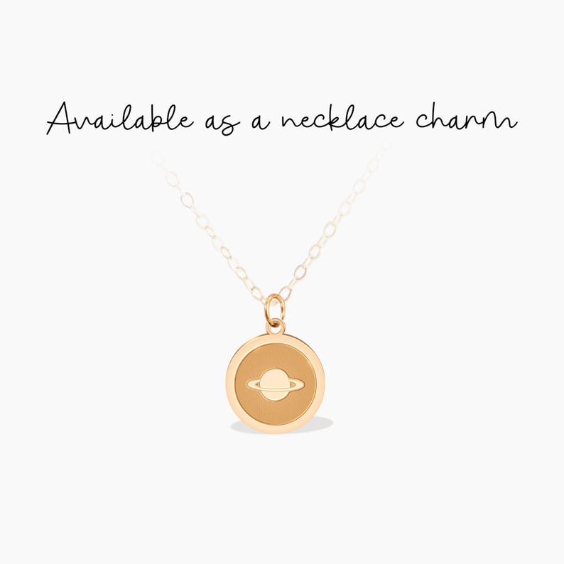 This gold charm pendant features a detailed Saturn design, perfect for space enthusiasts. Ideal for everyday wear or as a thoughtful gift for someone who loves astronomy, this charm adds a unique touch to any necklace.