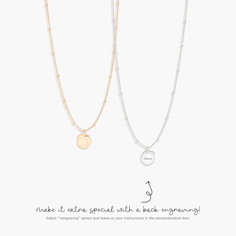 May include: Two necklaces with fine chains and small bead details. One is gold with a peach pendant, the other is silver with a round pendant engraved with the name "Oliver". The image includes text that reads "make it extra special with a back engraving!"