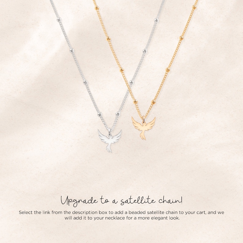 May include: Two delicate necklaces with a small bird pendant. One necklace is silver with a silver bird pendant, and the other is gold with a gold bird pendant. The necklaces are on a white background. Upgrade to a satellite chain! Select the link from the description box to add a beaded satellite chain to your cart, and we will add it to your necklace for a more elegant look.