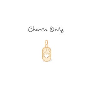 May include: Gold-colored charm pendant with a heart-shaped cutout and sunburst design. The charm is rectangular with rounded edges and includes the text "Charm Only".