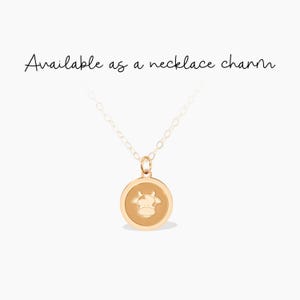 This charming gold cow pendant necklace is perfect for animal lovers or farmers. Its playful design adds a whimsical touch, making it a delightful gift for birthdays or special occasions.