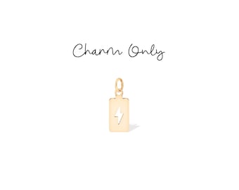 May include: A gold-coloured charm in the shape of a rectangle with a lightning bolt design. The charm has a small loop at the top for attaching to a necklace or bracelet. The text "Charm Only" is written above the charm.