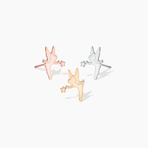 May include: Three pairs of fairy-shaped earrings in gold, rose gold, and silver.