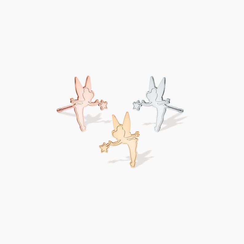 May include: Three pairs of fairy-shaped earrings in gold, rose gold, and silver.