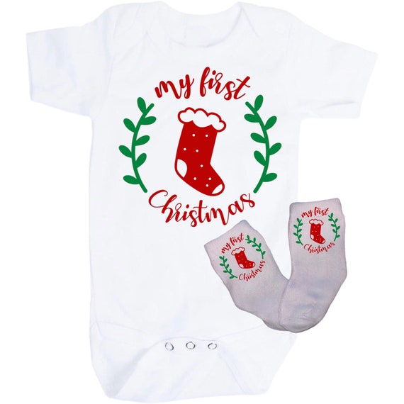 First Christmas Baby Bodysuit with Option to add Socks and No Scratch Mittens. Size 0-3 Months to 24 Months. EXCLUSIVELY FOUND HeRe!