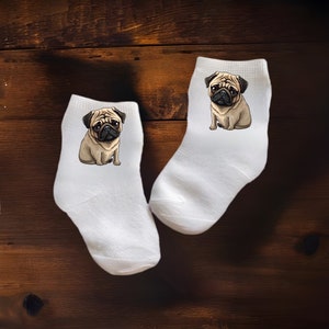 May include: A pair of white ankle socks with a cartoon pug printed on each sock.
